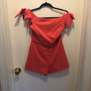 Coral romper with bow sleeve detail